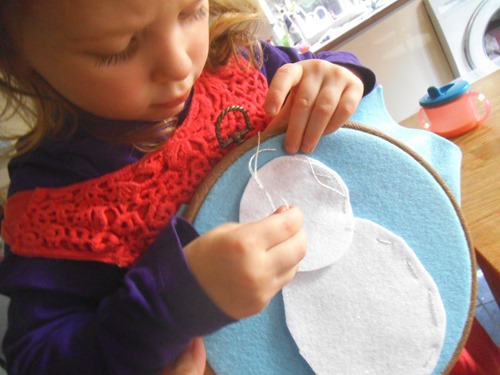 sewing a snowman on felt