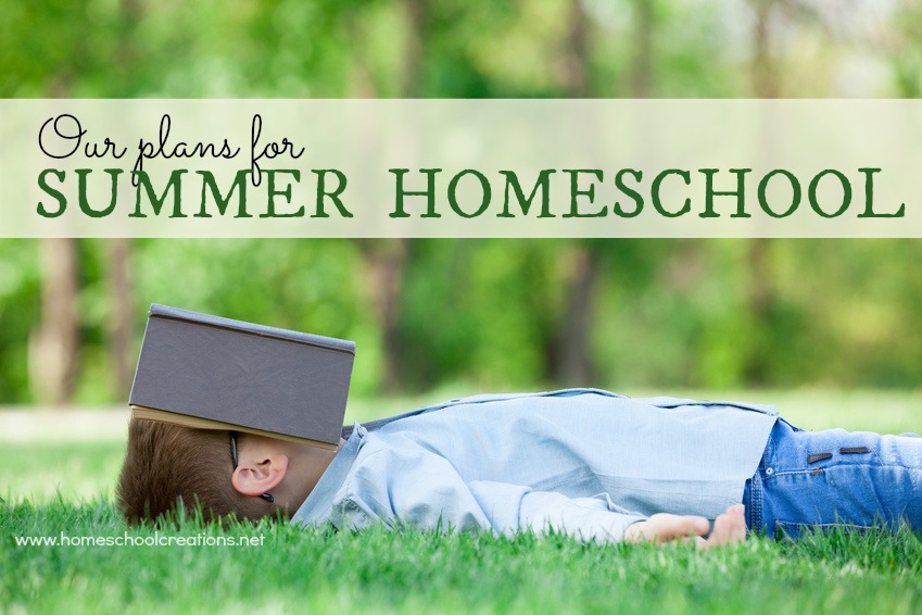 young boy with a book slipping on green grass in the park